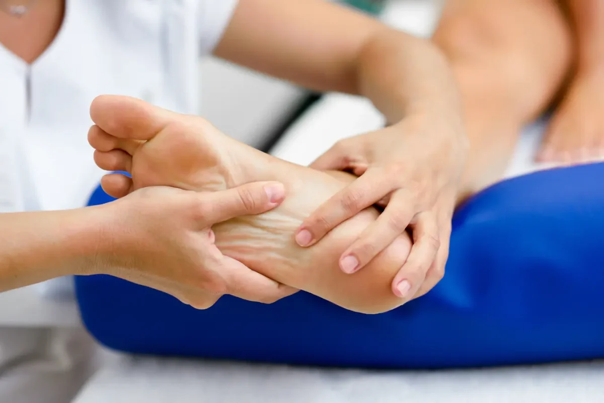 Podiatrist examining a patient's heel to diagnose heel pain and recommend treatment.