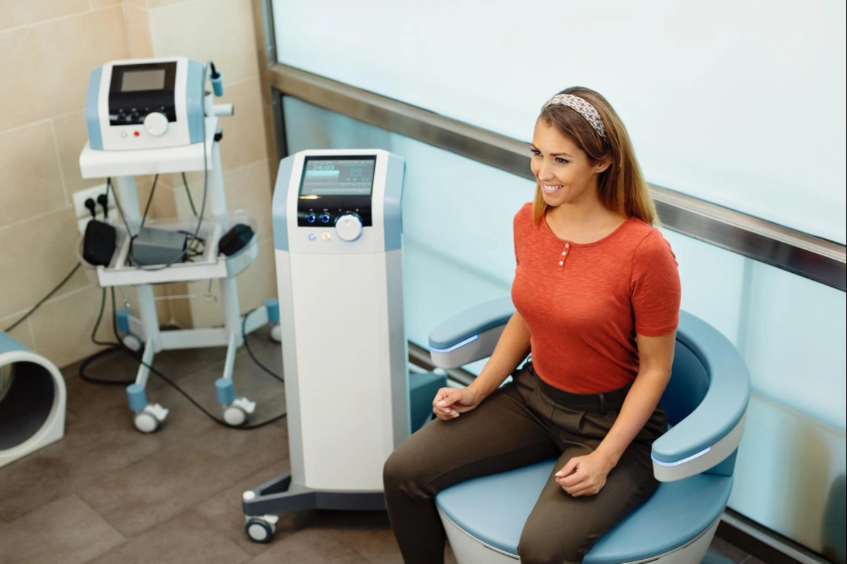 Woman receiving treatment with an Emsella chair